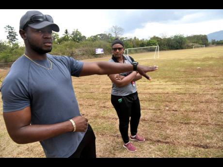 Assistant coaches Raheem Jackson (left), and Vanessa Levy speak of some of the difficulties faced by the school’s track and field programme. 