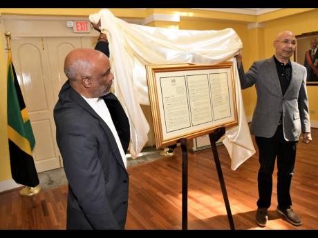 Sir Patrick Allen, (right) Governor General of Jamaica and Christopher Samuda, President of Jamaica Paralympic Association unveil the Proclamation which names March 11, 2023  Paralympic Day under the theme ‘I’m Phenomenal’ at the King’s House ballr