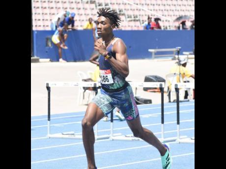 Roshawn Clarke strides to victory in the Under-20 boys' 400 metres hurdles at the Carfita Trials at the National Stadium today.