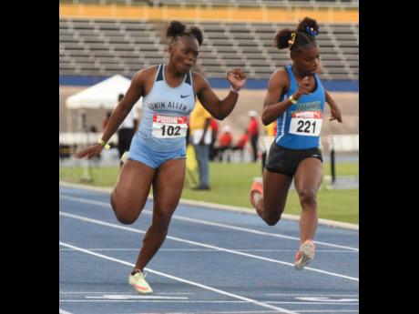 Edwin Allen's Serena Cole (left) wins the Under-20 girls' 100 metres ahead of Hydel's Alana Reid at the Carifta Trials at the National Stadium today. Cole clocked 11.18 seconds with Reid doing 11.24.