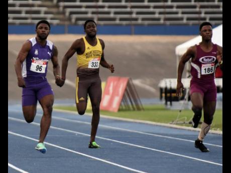 Kingston College's Bouwahjgie Nkrumie (left) strides to an easy victory over DeAndre Daley (right) of Herbert Morrison in the Under-20 boys' 100 metres final at the Carifta Trials at the National Stadium today. Nkrumie clocked 10.18 seconds, with Daley doi