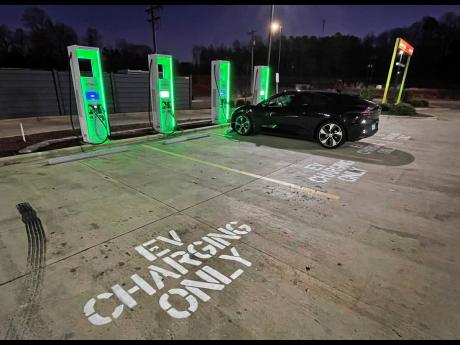 An electric vehicle is charged at an Electrify America charging station at a Sheetz convenience store along Interstate 85 in Hillsborough, North Carolina. 