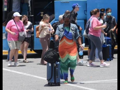 In this 2022 photo tourists are seen at Sangster International Airport, Montego Bay.