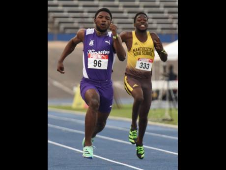 
Kingston College’s Bouwahjgie Nkrumie runs away with the under-20 boys’ 100 metres at the Carifta Trials inside the National Stadium last evening. At right is Manchester High School’s Javoon Blair.