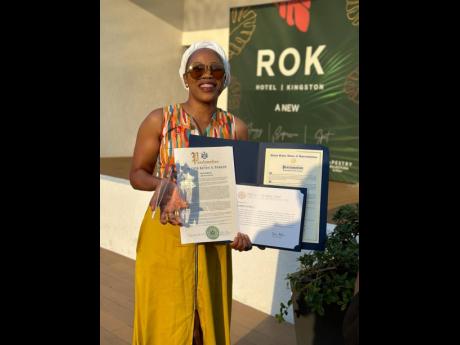 Queen Ifrica with the award and citations which she officially received last Friday.