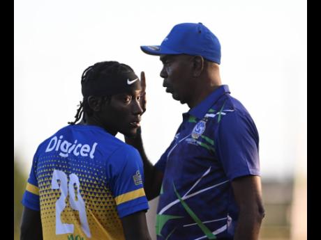 Harbour View’s coach Ludlow Bernard (right) speaks with Oshane Staple during his team’s Jamaica Premier League game against Cavalier late last year.