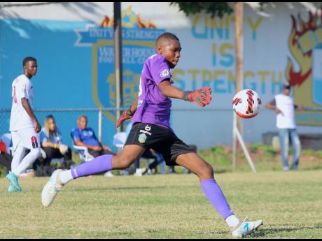 Waterhouse FC’s 15-year-old goalkeeper Kevin Hibbert, makes a clearance during a Jamaica Premier League game against Chapelton Maroons at the Waterhouse Stadium on Sunday.