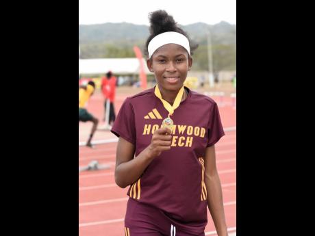 Holmhood Technical High School’s Jodyann Mitchell displays her gold medal after breaking the girls’ Class I 1500 metres record at Central Champs 2023. at the G.C. Foster College two weeks ago.