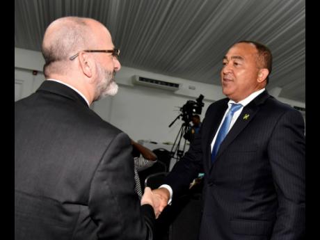 Health and Wellness Minister Dr Christopher Tufton (right) greets Ian Stein, PAHO/WHO representative to Jamaica, during the launch of the Ministry of Health and Wellness’ Problem Management Plus initiative at the Spanish Court Hotel in St Andrew on Tuesd