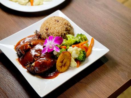 The jerk chicken is served with traditional rice and peas, steamed vegetables and fried plantain.