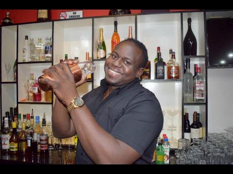Shaking with a smile, Burgess takes us step by step through his dark rum daiquiri mix making process.