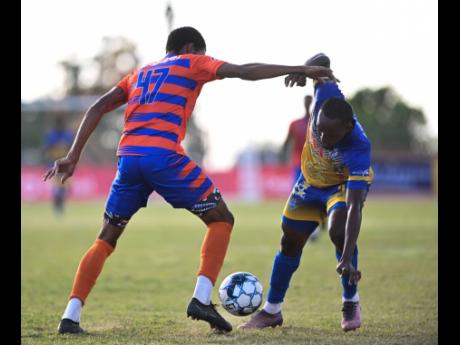 Harbour View’s Nicholas Hamilton (right) drops his shoulder in an attempt to get by Montego Bay United’s Renardo Wellington during the teams’ Jamaica Premier League encounter at the Jamaica College Ashenheim Stadium back in January.