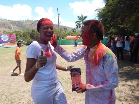  Indian High Commissioner to Jamaica Runsung Masakui applies powder to a laughing face.