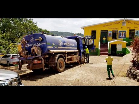 A water truck from Discovery Bauxite arrives at Retirement Primary School, St Ann.