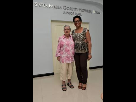 Because of her significant contributions to the Alpha Boys Home as an icon, the Alpha School of Music was named after Sister Goretti in her honour. She shares lens time with Marcia Dallas, administrative assistant (right).  