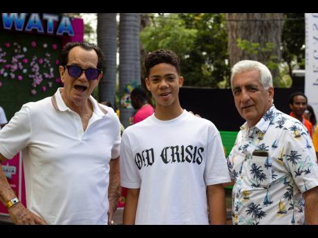 From left: Downsound Entertainment CEO Joe Bogdanovich was shouting out soca lyrics like a true bacchanalist as he and his son, Josef ‘Joey’ Bogdanovich III, are welcomed by Bacchanal Co-director, Michael Ammar Jr.