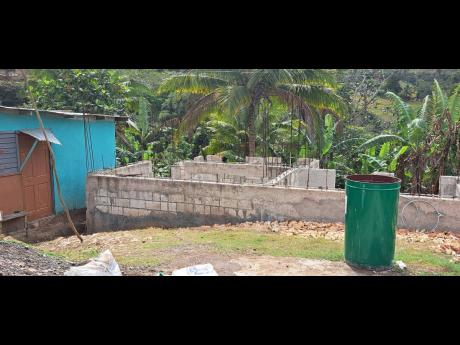 Beverly Gordon has halted construction on her house as a result of the eviction threat in Pleasant Hill, St Catherine. Several families were last October served notice to vacate the state lands which they had been occupying for decades.