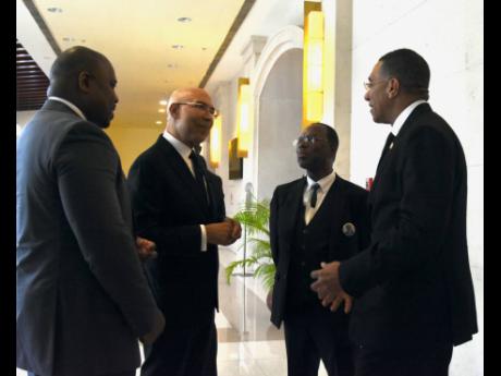 Governor General Sir Patrick Allen (second left) in conversation with Prime Minister Andrew Holness (right); Ewen Corrodus’ nephew, Shane Corrodus (left); and brother, Fontley Corrodus, at the thanksgiving service on Sunday.