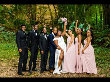 Basking in the feeling of forever, the newlyweds share a beautiful moment with the supportive bridal party. 