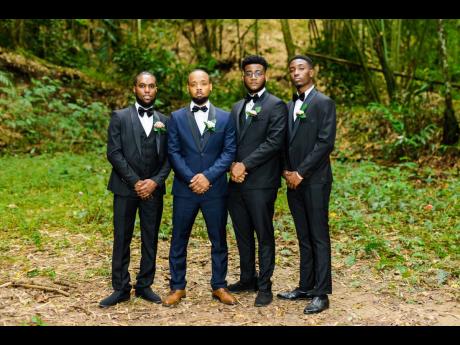 Suited for his nuptials in blue, the handsome groom is joined by his best man Nicholas Lawrence (left) and groomsmen Shaquiel Brooks (second right) and Sheldon Llewellyn (right), all decked out in black and white. 
