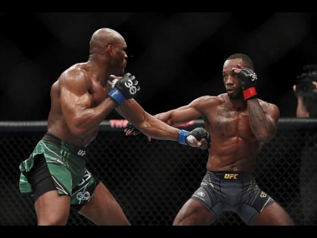 Leon Edwards (right) faces off against Kamaru Usman during their welterweight title bout at the UFC 286 mixed martial arts event Saturday March 18, 2023, in London. 