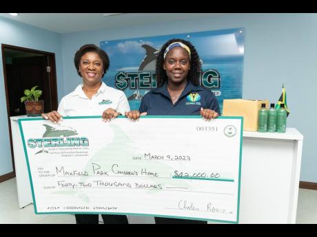 Michelle Valentine (left), assistant vice-president of marketing and communications at Sterling Asset Management, presents a cheque of $42,000 to Renae Tuckett Palmer, manager of Maxfield Children’s Home. She expressed her gratitude by saying, ‘This su