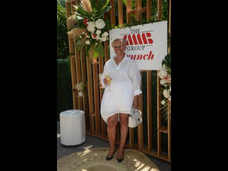 JMMB client Bernice De Morasse is chic in her white shirt dress paired with emerald pumps.