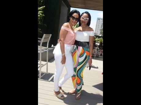 JMMB’s Suzanne Hendricks (left), marketing officer, and Fornia Young, general manager, client partnership, JMMB, pause for a photo at the recent JMMB brunch held at AC Hotel Kingston. 