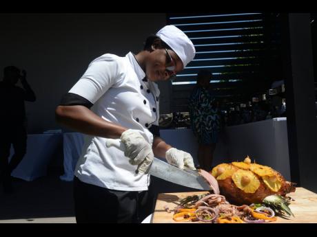 Anissa Chephas, chef at AC Hotel Kingston, carves some succulent ham slices for clients.