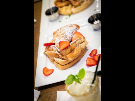 Fridays French toast — four slices of golden French toast finished with a dash of powdered sugar and served with fresh strawberries.