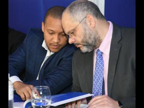 Deputy Chairman Paul Simpson (left) and Chairman Mark Myers of both Barita Investments and Cornerstone, consult during a meeting in 2019.