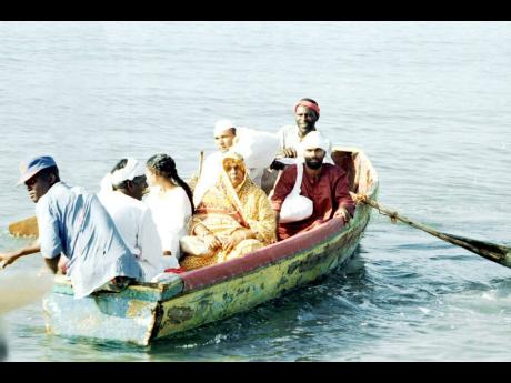 In this 1995 photo, a group enacts the arrival of Indian indentured labourers to Jamaican shores. 