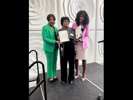 Abigail Hamilton (centre) accepts her certificate from Candace Walker (left) and Gwyneth Chapman (right), both from the city of Brampton, representing Mayor Patrick Brown.