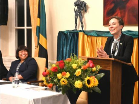Senator Kamina Johnson Smith addressing the audience at the community meeting held at the Jamaican High Commission. Looking on at left is Acting High Commissioner Mrs Patrice Laird Grant.