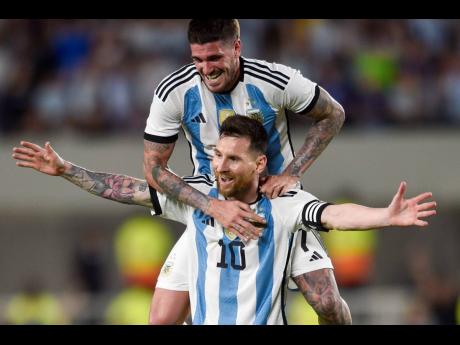 Argentina’s Lionel Messi celebrates with teammate Rodrigo De Paul scoring his side’s second goal against Panama during an international friendly  match in Buenos Aires, Argentina, Thursday, March 23, 2023. 