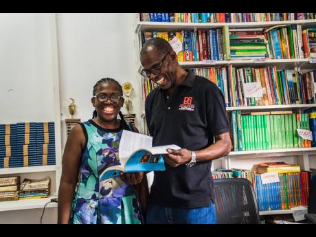 Founder and events manager of the Eastwood Gardens Youth Club, Juliana Prince (left), proudly shows D&G Foundation Accountant Dennis Beckford, the recent renovations to the club’s library. The renovations were completed using a $1 million grant from the 