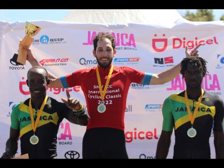 American Andy Scarano (centre) holds aloft the trophy for placing first in stage one of last year’s Jamaica Montego Bay International Cycling Classic ahead of  second place finisher Barrington Bailey (left) and Jerome Forrest who placed third. 