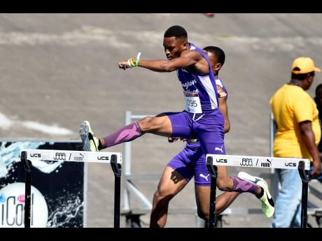 Kingston College’s Antonio Forbes clears a hurdle on his way to winning the Class One boys’  400 metre hurdles at the S.W.  Isaac-Henry Invitational at the National Stadium on February 18.