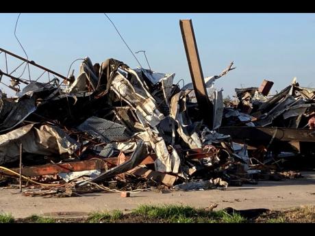 Debris covers a damaged structure in Rolling Fork, Mississippi on Saturday. Powerful tornadoes tore through the deep south Friday night, killing several people in Mississippi and obliterating dozens of buildings.