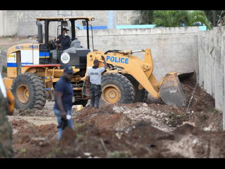 
In this 2020 photo, in a joint operation, members of the Jamaica Defence Force and Jamaica Constabulary Force search for illegal guns in Stadium East, St Andrew. 