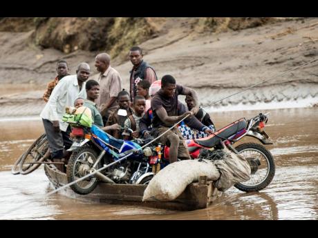 Men transport their salvaged belongings in Chiradzulu, southern Malawi. During a conference in the Ethiopian capital of Addis Ababa on March 20, leaders of African countries hit hard by climate change discussed finance options that would allow for the forg