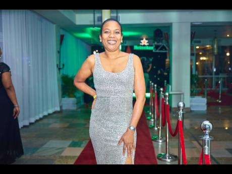 Marsha Palmer, solution delivery specialist at Red Stripe, sparkles on the red carpet in a form-fitting sequinned dress. 
