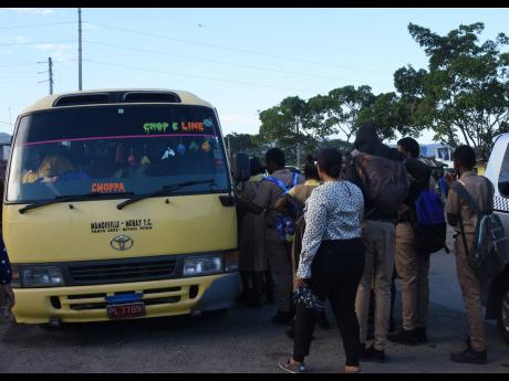 Loitering students seen this February photo, being ushered into a bus by their principals and school administrators at Montego Bay Transportation Centre.