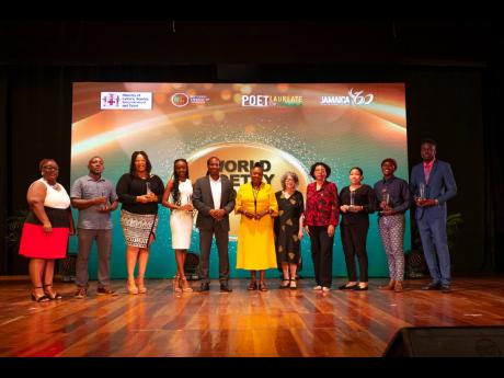 Minister of Culture, Gender, Entertainment and Sport  Olivia Grange and State Minister Alando Terrelonge with Olive Senior, Poet Laureate of Jamaica; the poetry prize winners; Joy Douglas, chairman of the Board of Management, NLJ; and National Librarian Be
