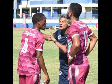 Chapelton Maroons coach Clovis de Oliveira, (centre) gives instructions to Raushan Ritch (left) and, Kristoff Graham during the Jamaica Premier League match against Montego Bay United at Ashenheim Stadium, Jamaica College yesterday. 