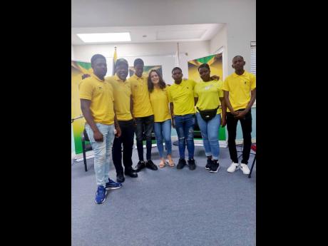 Popular social media vloggers Wayne Marshall (second left) and his wife Tami (fourth left) entertained and gave a motivational talk to paralympian athletes during Paralymic Day recently. 
