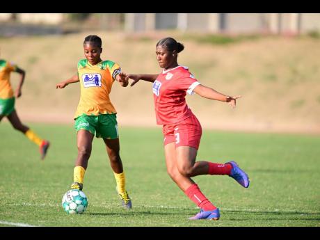 Shaneil Buckley (left) of Excelsior High in action against Bridgeport High’s Jasmin Thompson during a recent ISSA TIP Friendly Society schoolgirls football match at the Stadium East field. 