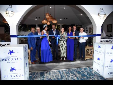 The official ribbon-cutting ceremony for The Jamaica Pegasus hotel pool, pool bar and lounge, and garden was conducted by (from left) Sheldon Seymour, general manager for The Jamaica Pegasus hotel; Metry Seaga, deputy chairman of Petrojam Limited; Miss Jam