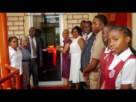 Minister of Education and Youth Fayval Williams (fourth left) cuts the ribbon to officially open a new computer laboratory at Ferncourt High School in St Ann on Sunday, March 26, following the 85th anniversary church service held at the St Matthew’s Angl