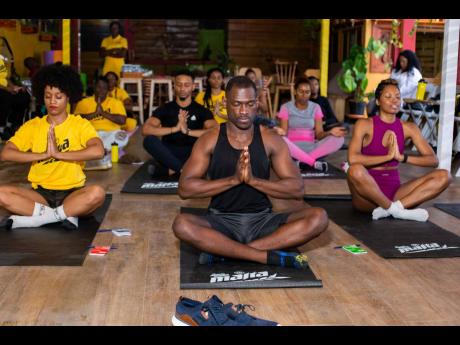 Fitness and wellness enthusiasts enjoy a moment of tranquillity through meditation and deep breathing.